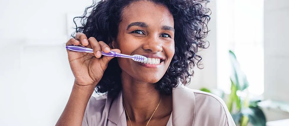 Woman brushing teeth