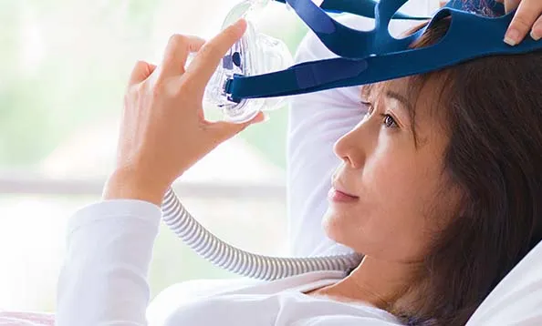 Woman using CPAP machine